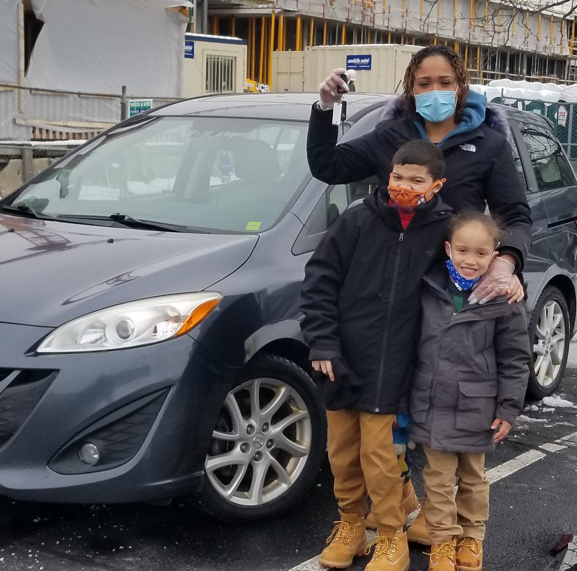 GNG client Sedenia and her children in front of their new car