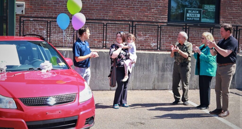 A small gathering while GNG awards a donated car.