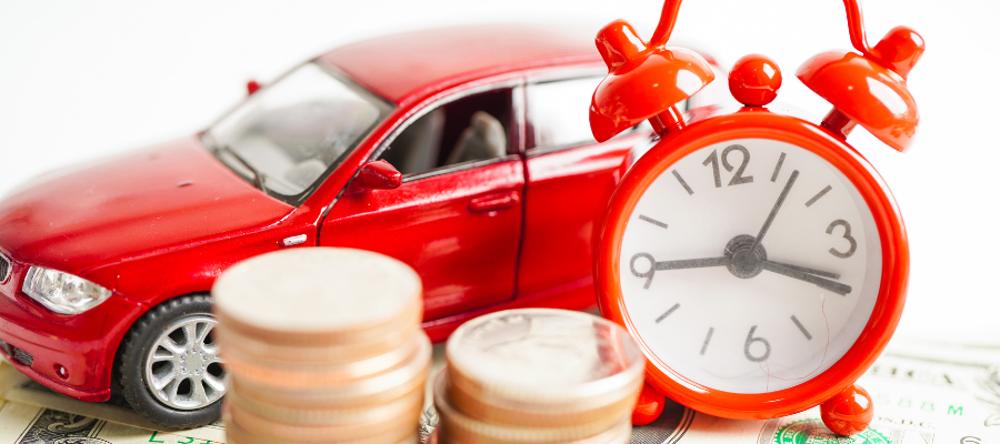 toy car with alarm clock and coins